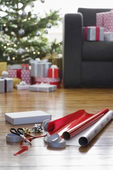 Wrapping paper and accessories for Christmas on hardwood floor
