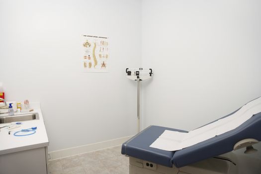 Weight scale, bed and doctor's desk in the clinic
