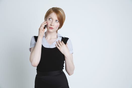 Studio shot of businesswoman talking on mobile phone