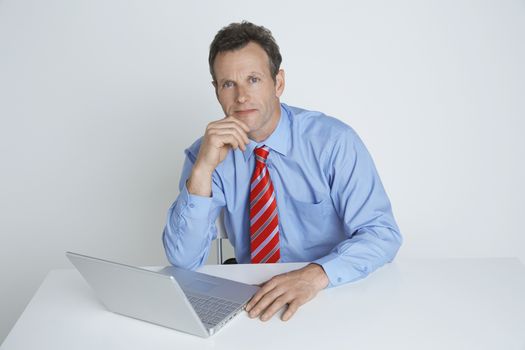 Studio shot of businessman with laptop