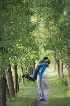 Young Couple Hugging on Tree Lined Path