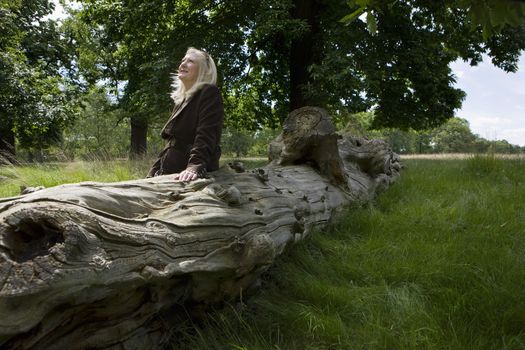 Woman Sitting on a Dead Tree