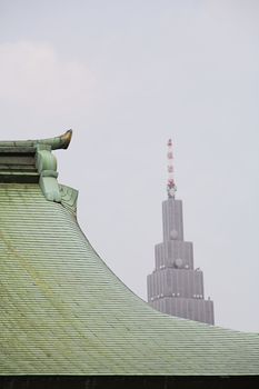 Modern Skyscraper Behind Traditional Roof of Meiji Shrine