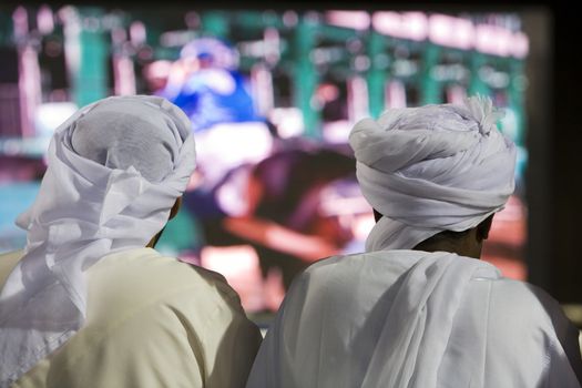 Dubai UAE Two men traditionally dressed in dishdashs and gutras
