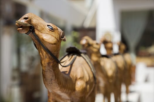 Wooden carved camels displayed for sale in the old Bastakia Quarter in Bur Dubai, Dubai, UAE