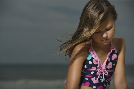 Sad Little Girl on a Beach