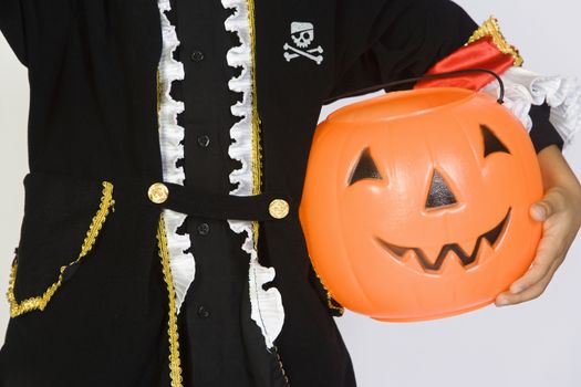 Boy (7-9) wearing Halloween costume with jack-o-lantern