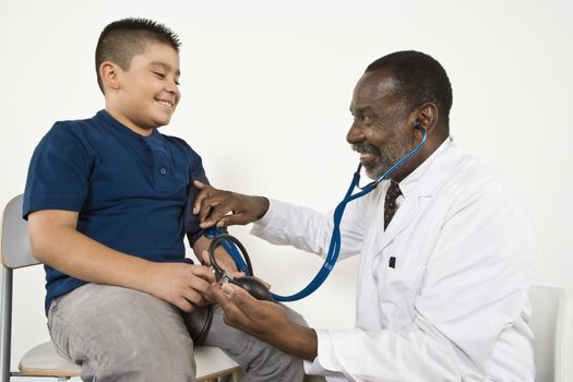 Doctor examining pre-teen (10-12) boy