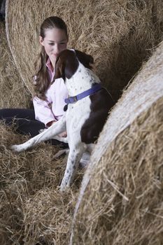 Girl and dog in barn