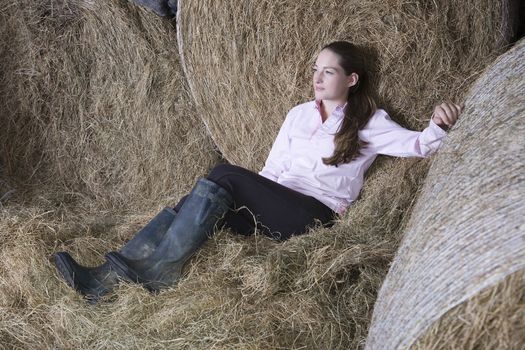 Girl relaxing in barn