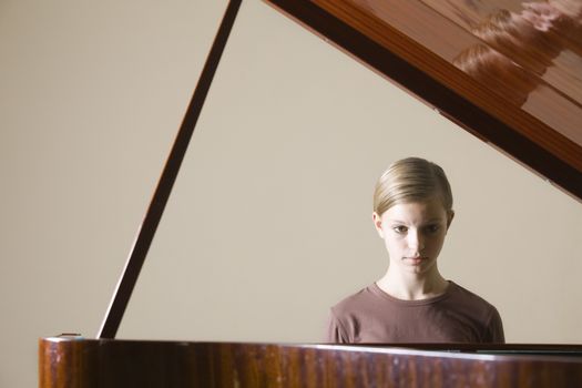 Girl (13-15) playing piano