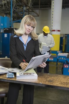 Smartly dressed woman working in newspaper factory