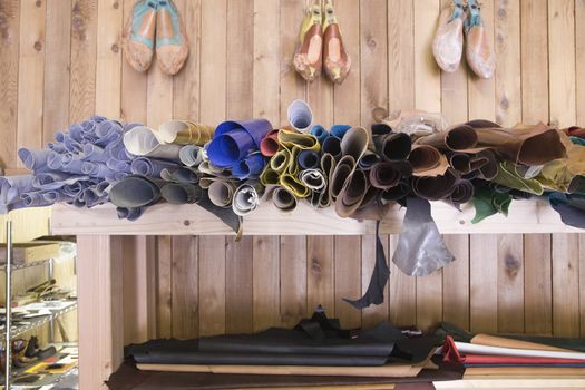 View of footwear materials in shelves at traditional shoemaker workshop