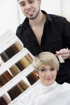 Hairdresser suggesting hair shades to customer