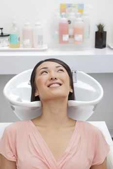 Woman getting her hair washed at beauty salon