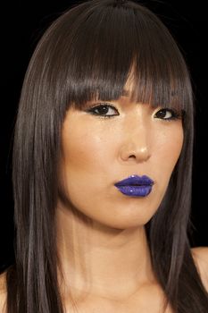 Young woman with vibrant blue lipstick