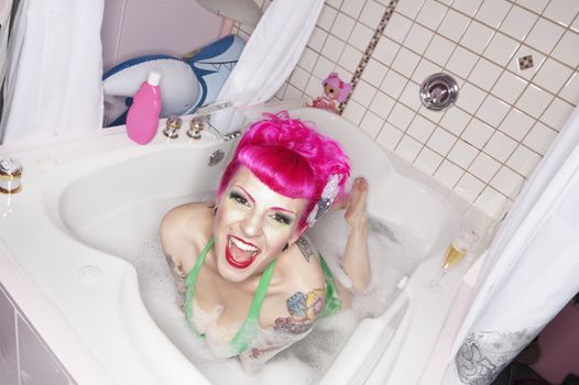 Portrait of pink haired woman in bathtub
