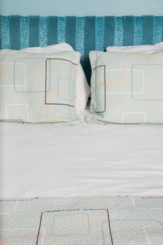Close-up of neat and tidy bed with pillows