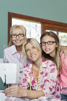Portrait of granddaughter, grandmother and mother with sewing machine