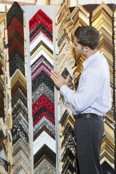 Young man browsing at a frame store