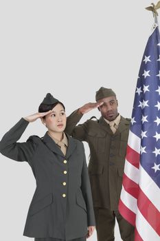Multi-ethnic US military officers saluting American flag over gray background