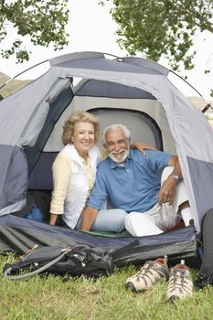 Senior couple at entrance to tent