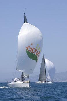 Two yachts compete in team sailing event California