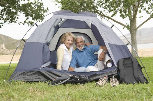 Senior couple at entrance to tent