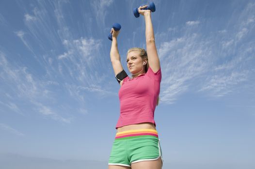 Young woman lifting hand weights