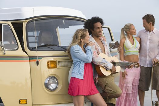 Group of young people with camper van