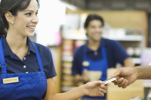 Supermarket employee in blue apron
