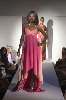 Woman in pink dress on fashion catwalk