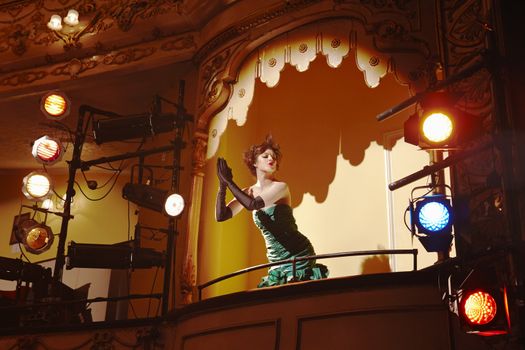 Low angle view of a beautiful young woman in theatre box