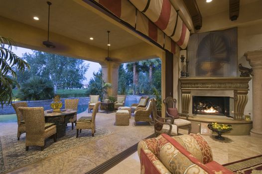 Open plan sitting room by lit fire with view of porch