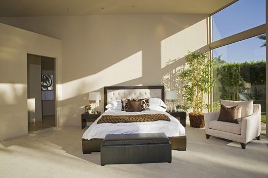 View of a spacious sunlit bedroom with porch view