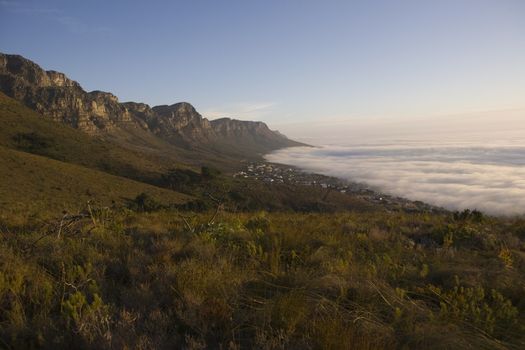 The 12 Apostles of Table Mountain tower above Camps Bay and Bakoven