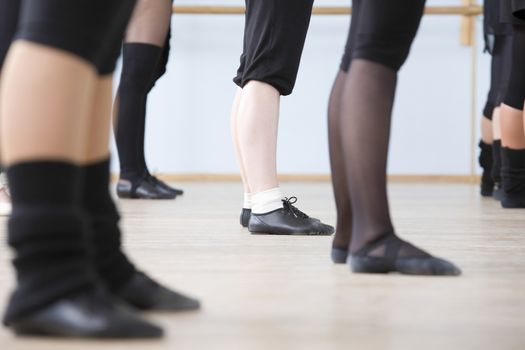 Young women practise ballet in a rehearsal room