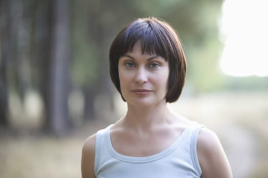 Mid adult woman stares directly at camera portrait