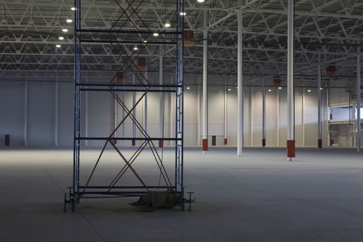 Large empty storehouse with scaffold