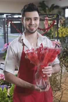 Florist stands with dried red flowers