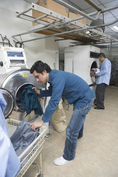 Man loading clothes into the washing machine