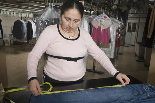 Mature woman measuring in the laundrette