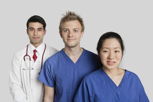 Portrait of diverse medical team standing over gray background
