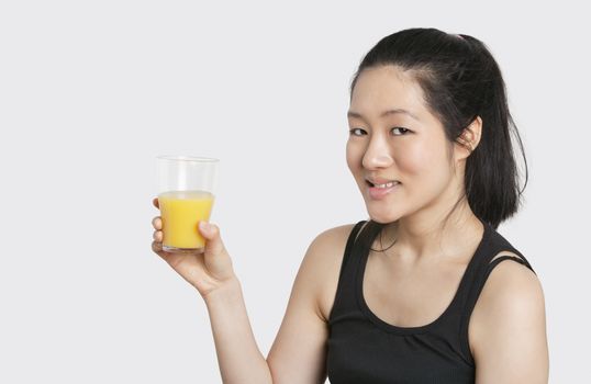 Portrait of a beautiful woman having a glass of orange juice