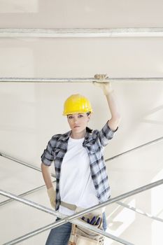 Portrait of a mid adult woman standing under scaffold