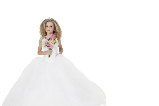 Girl in wedding dress holding flower bouquet while looking away over white background