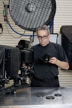 Front view of a technician in photographer's studio