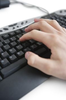 Cropped image of a hand on computer keyboard