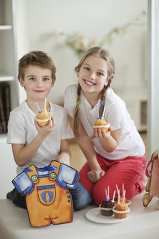 Portrait of little boy and girl with cup cakes
