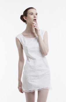 Young woman in dress daydreaming over white background